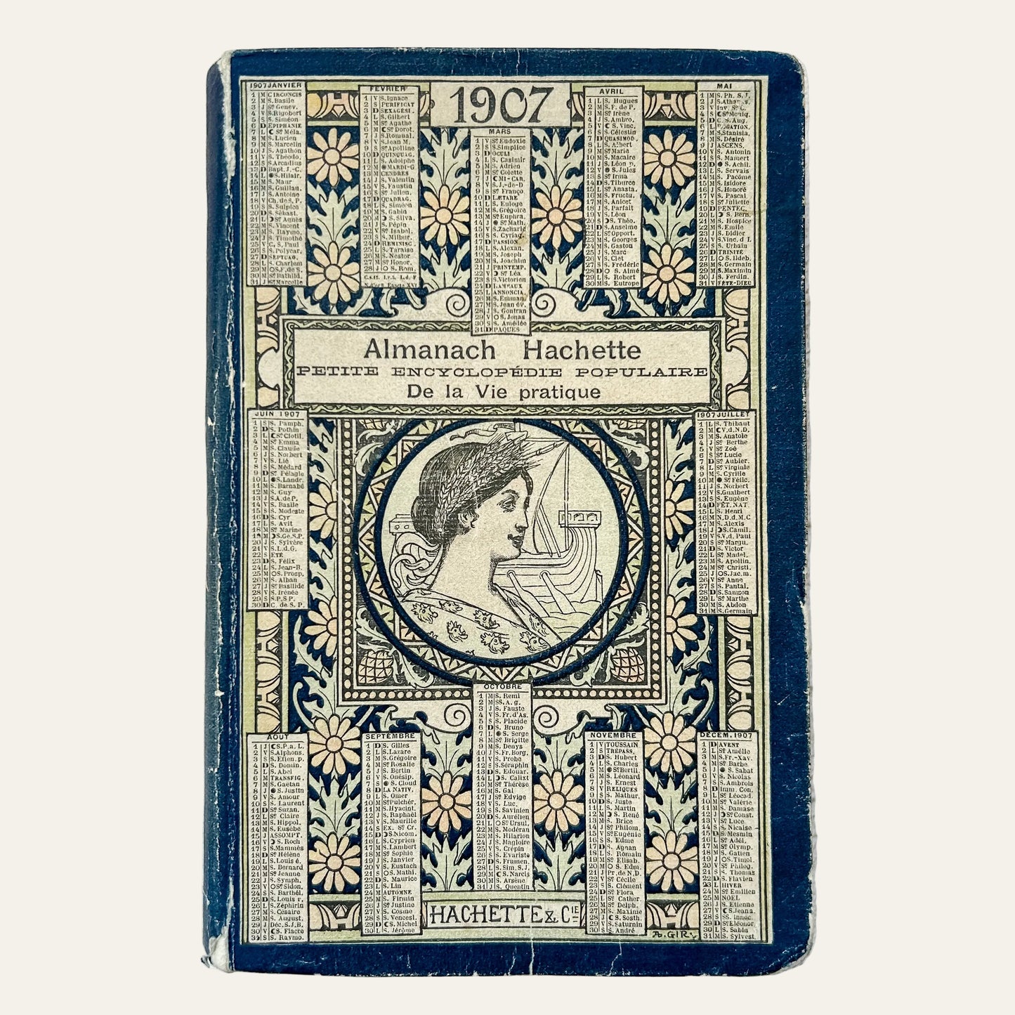 Vintage book cover of 'Almanach Hachette' from 1907 on a textured surface