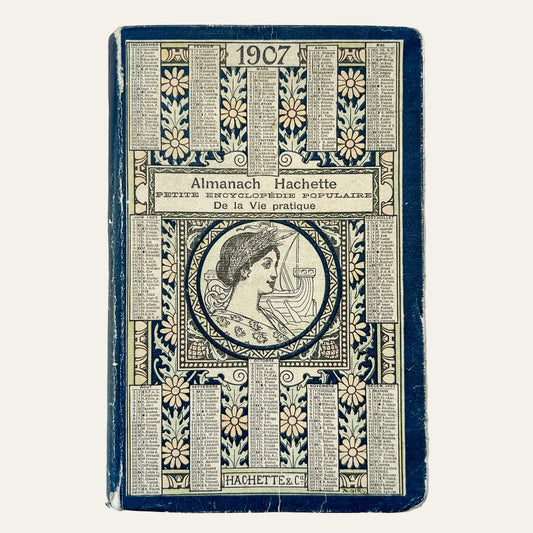 Vintage book cover of 'Almanach Hachette' from 1907 on a textured surface