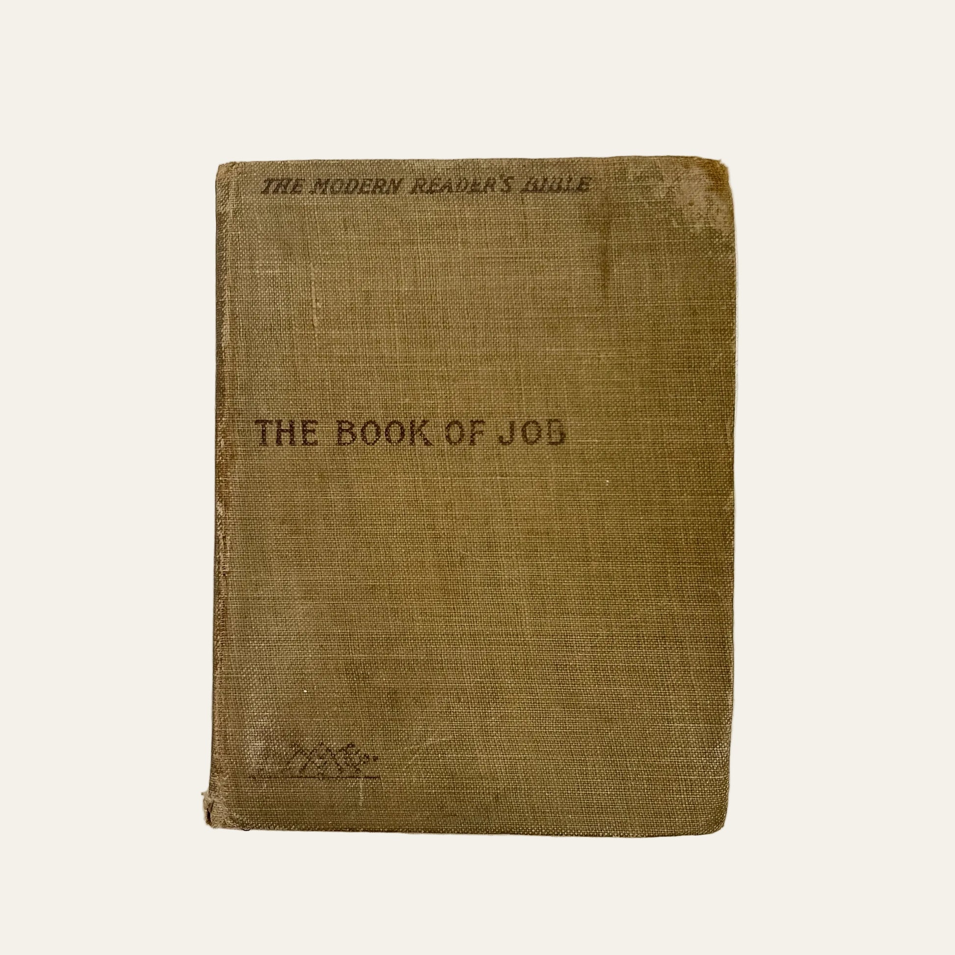 Vintage book titled 'The Book of Job' on a textured white surface