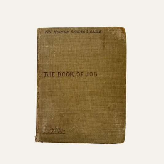 Vintage book titled 'The Book of Job' on a textured white surface