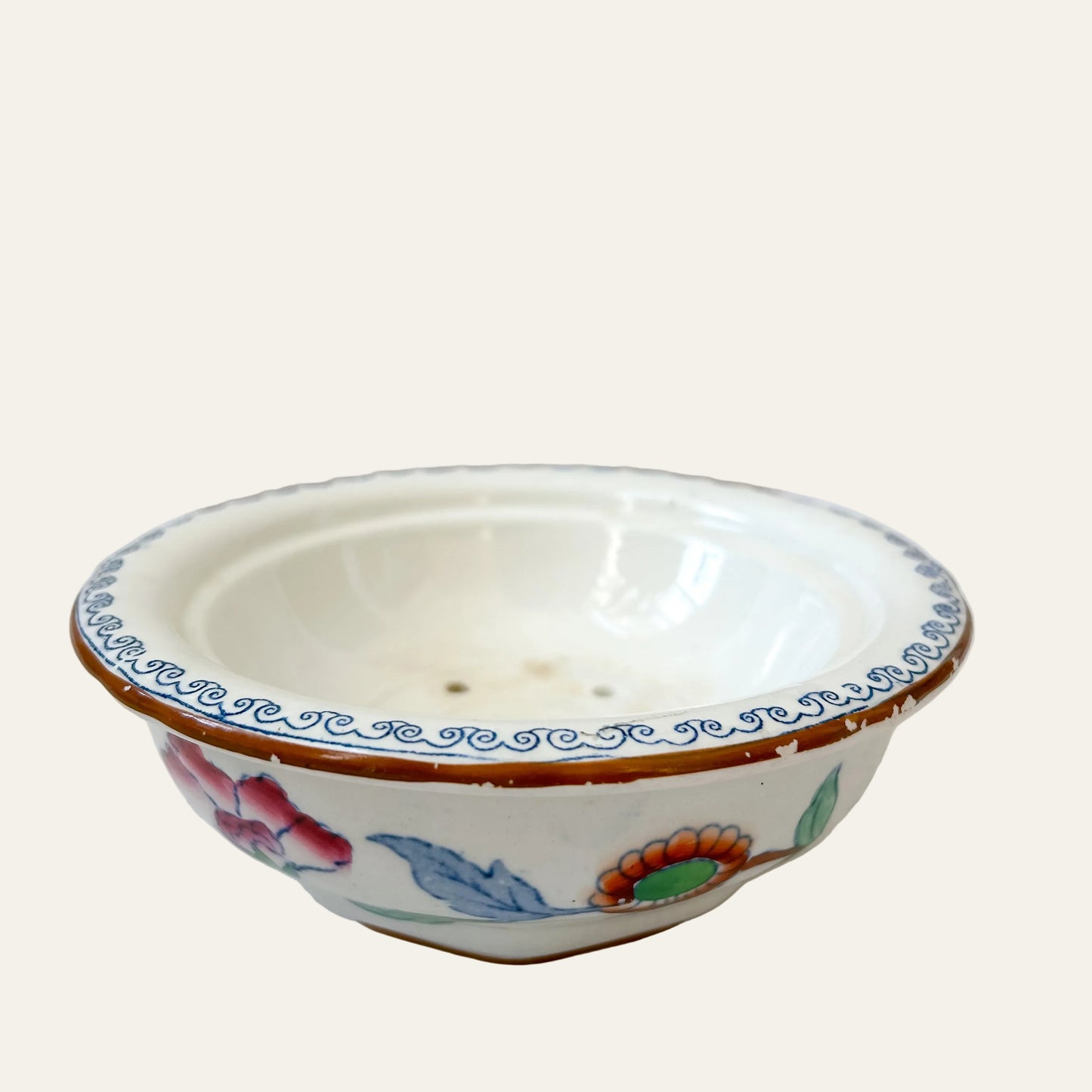 Decorative ceramic bowl with colorful patterns on a light background