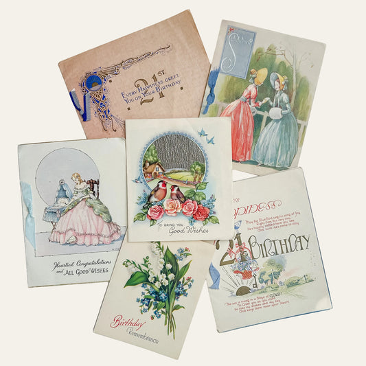 Collection of vintage birthday cards on a textured surface