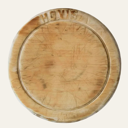 Wooden bread board with 'HOVIS' branding on a light background