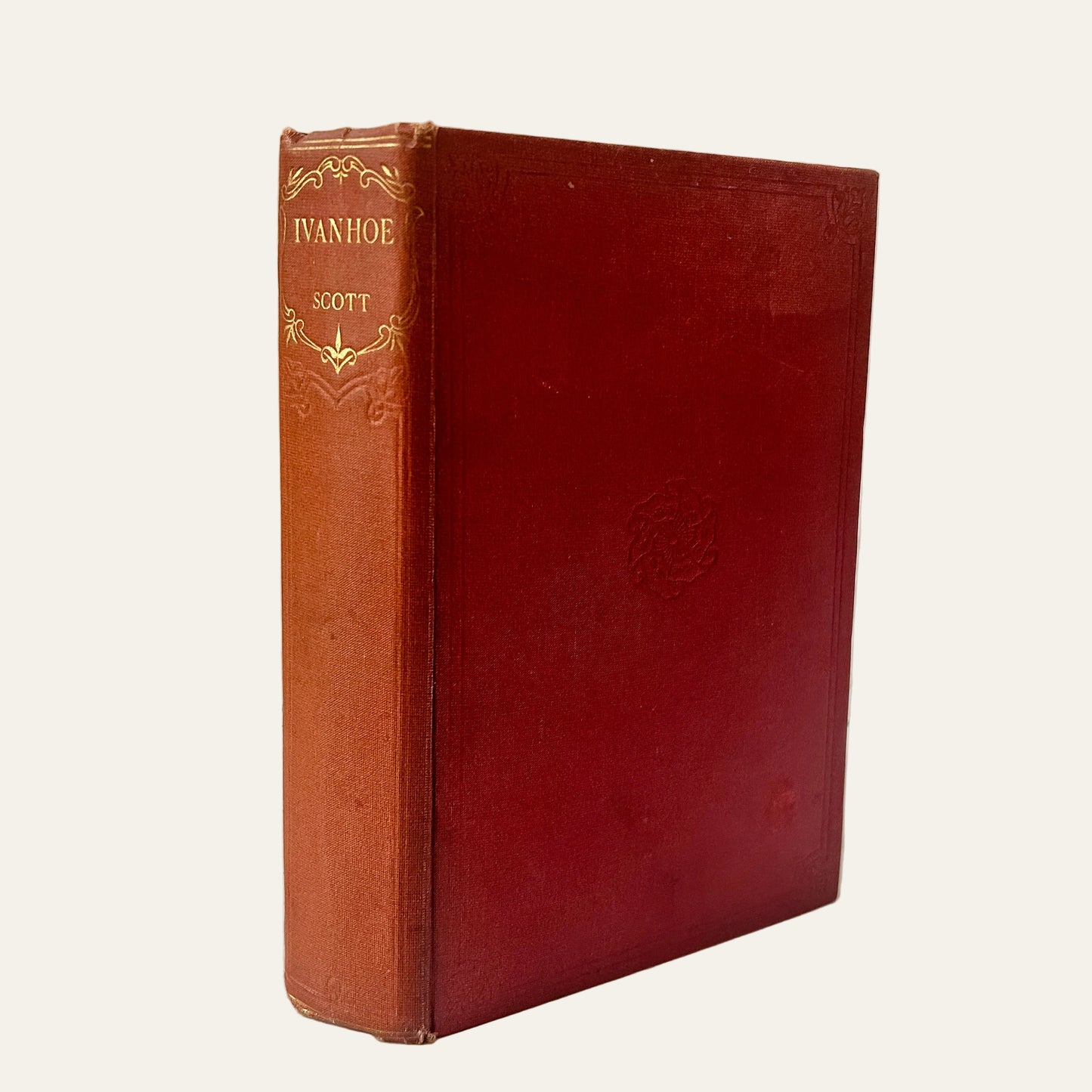 Vintage red leather book titled 'Ivanhoe' by Scott on a light background