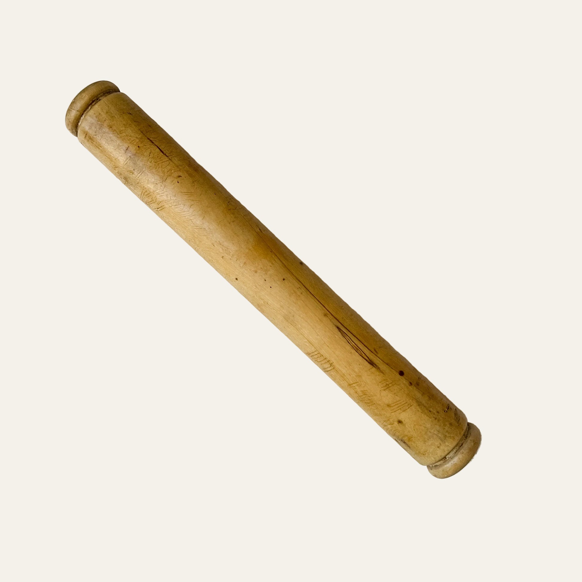 Wooden rolling pin on a light gray surface