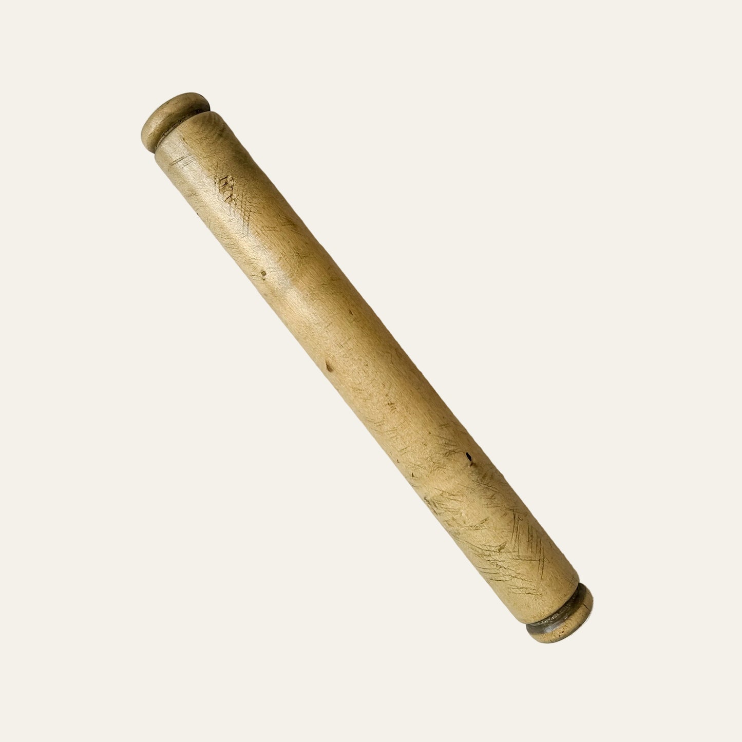 Wooden rolling pin on a textured surface