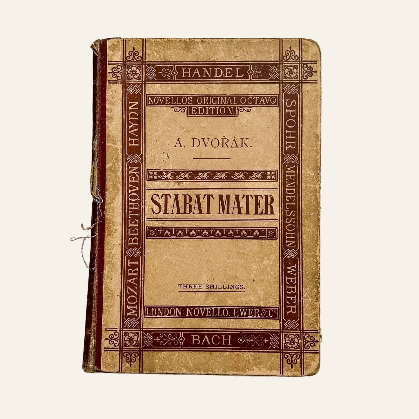 Vintage music score book titled 'Stabat Mater' on a textured white background