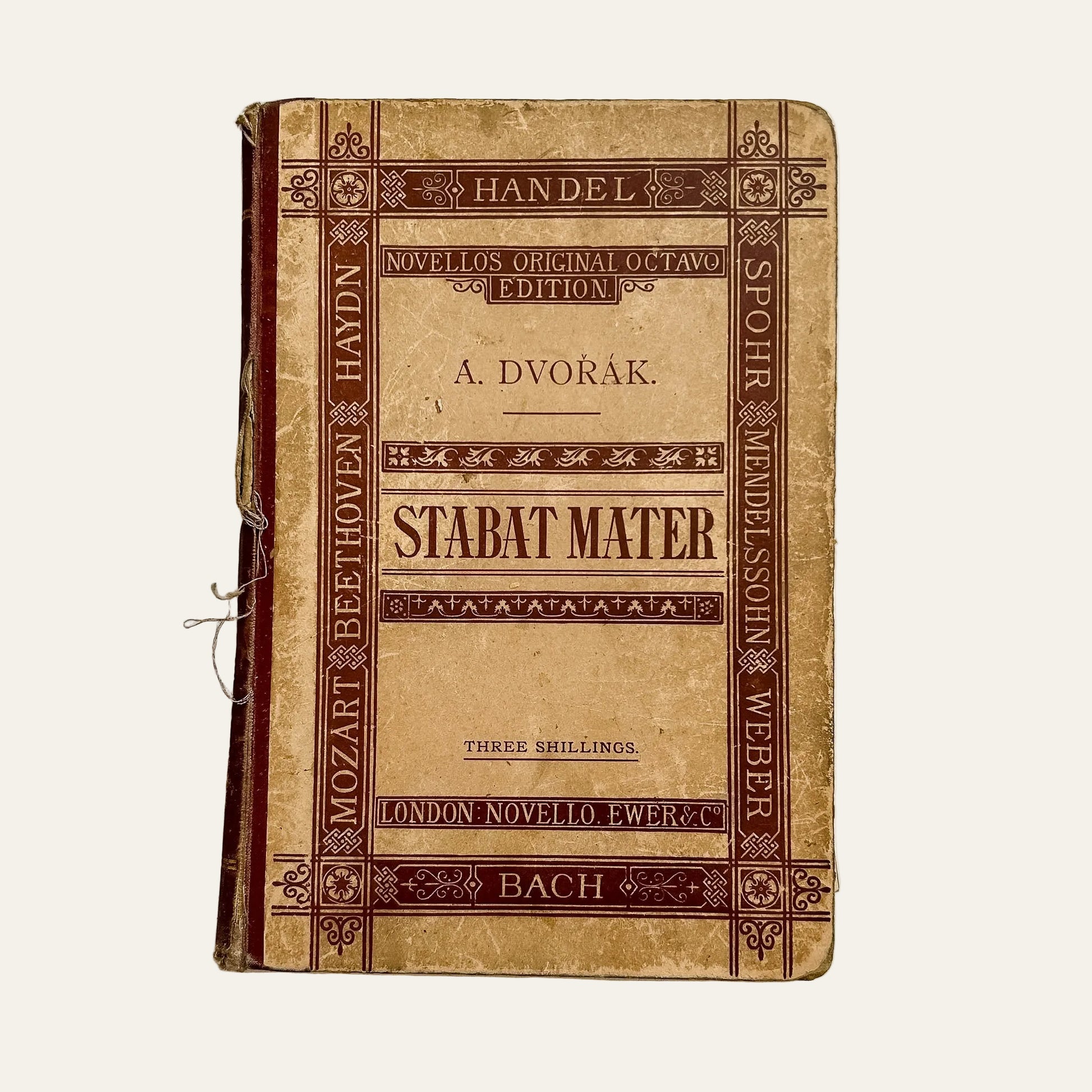 Vintage music score book titled 'Stabat Mater' on a textured white background